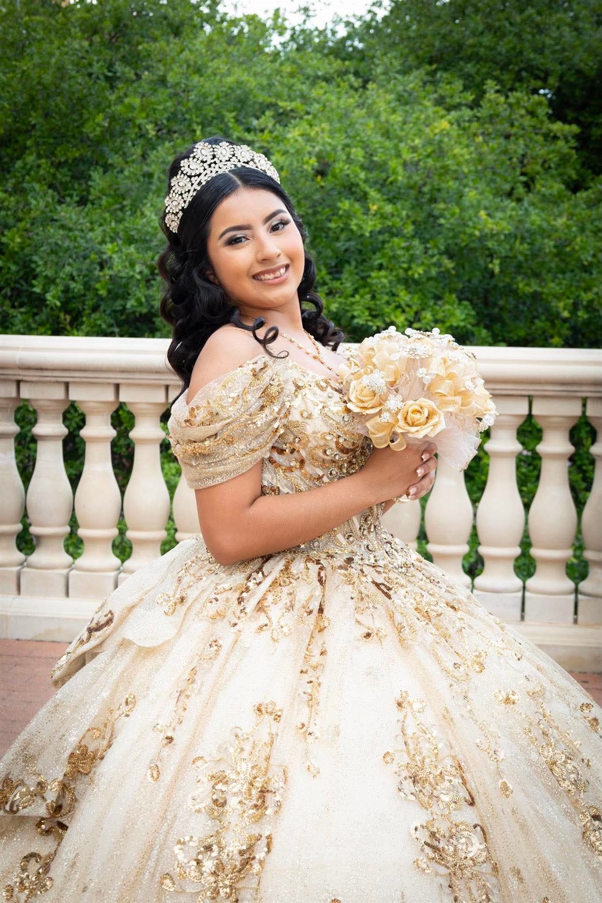 Quinceañera portrait with a gold bouquet