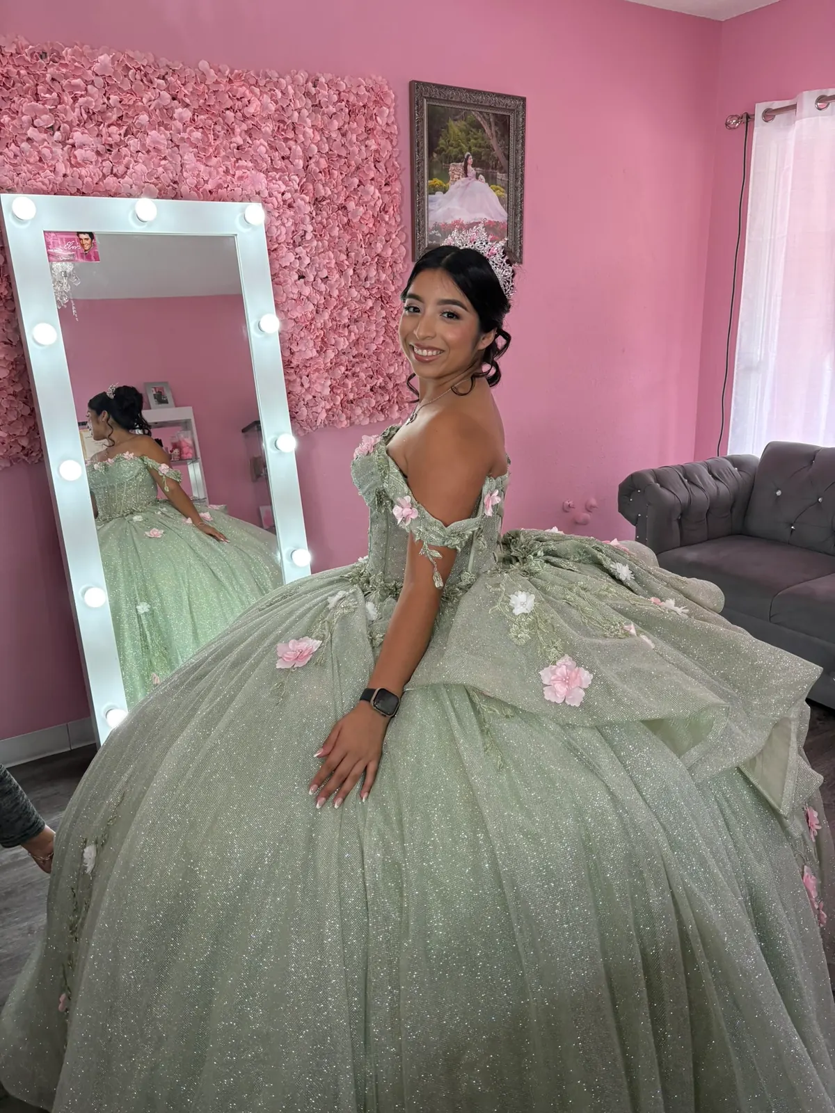Quinceañera in a green gown photographed in the beauty studio