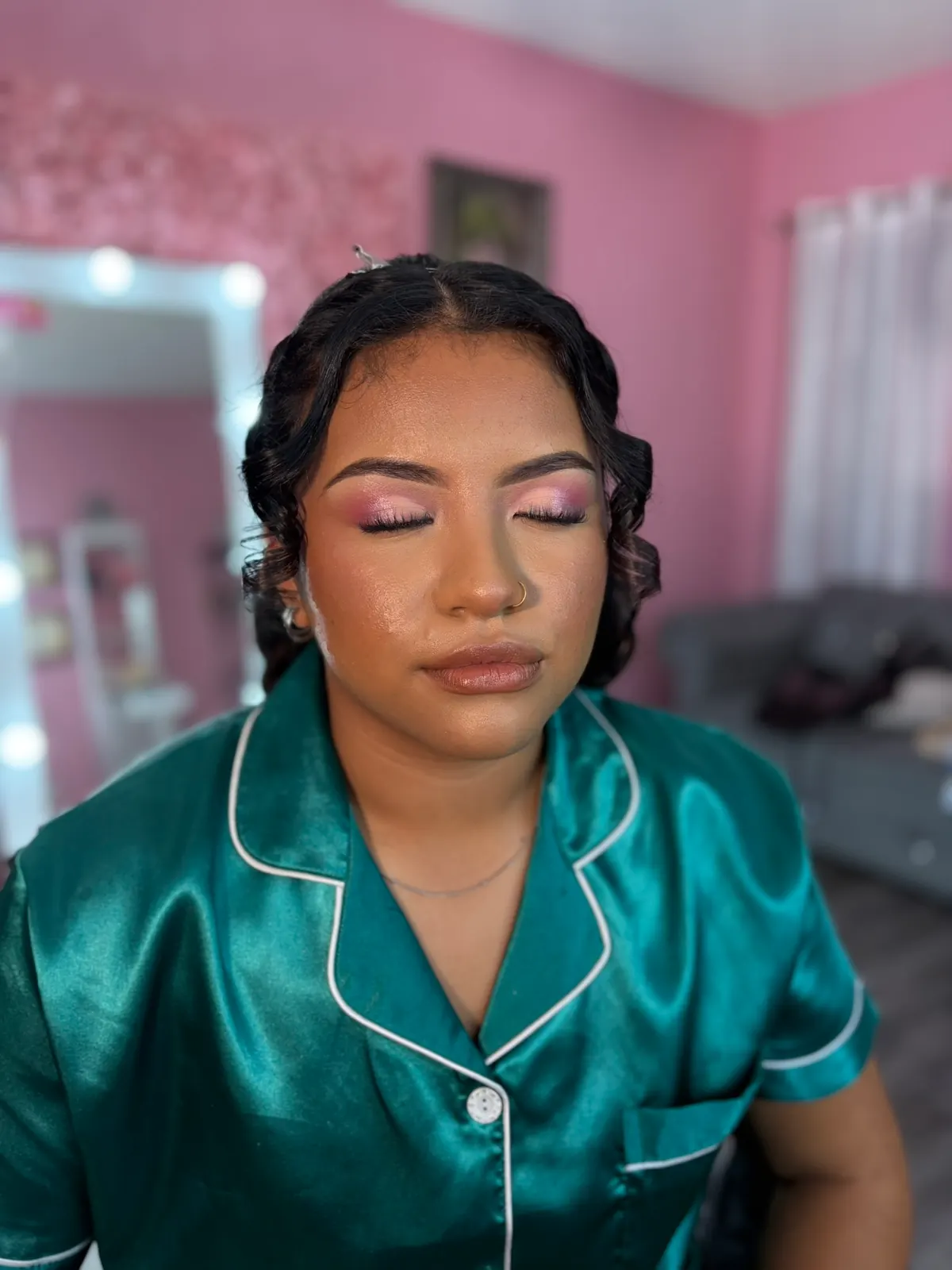Soft glam makeup with curled hair and a green satin robe