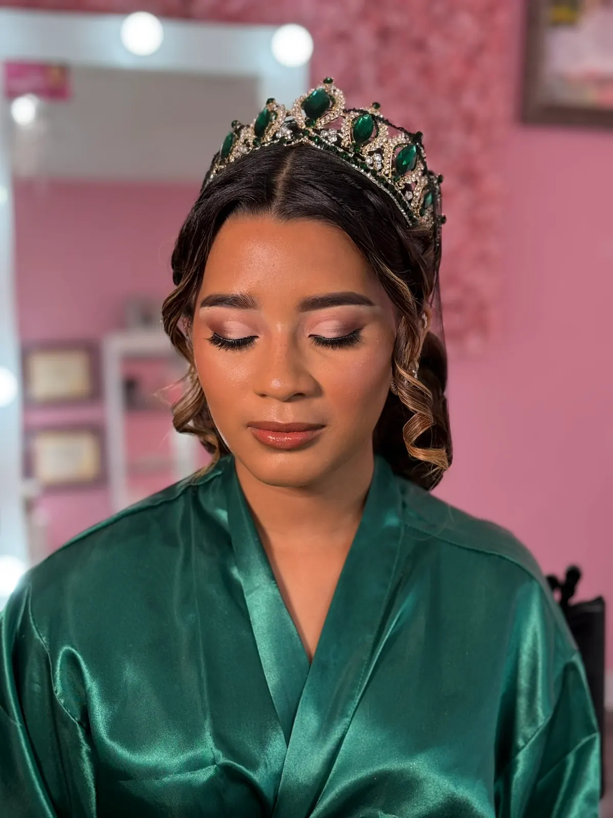 Quinceañera beauty portrait with tiara and green satin robe