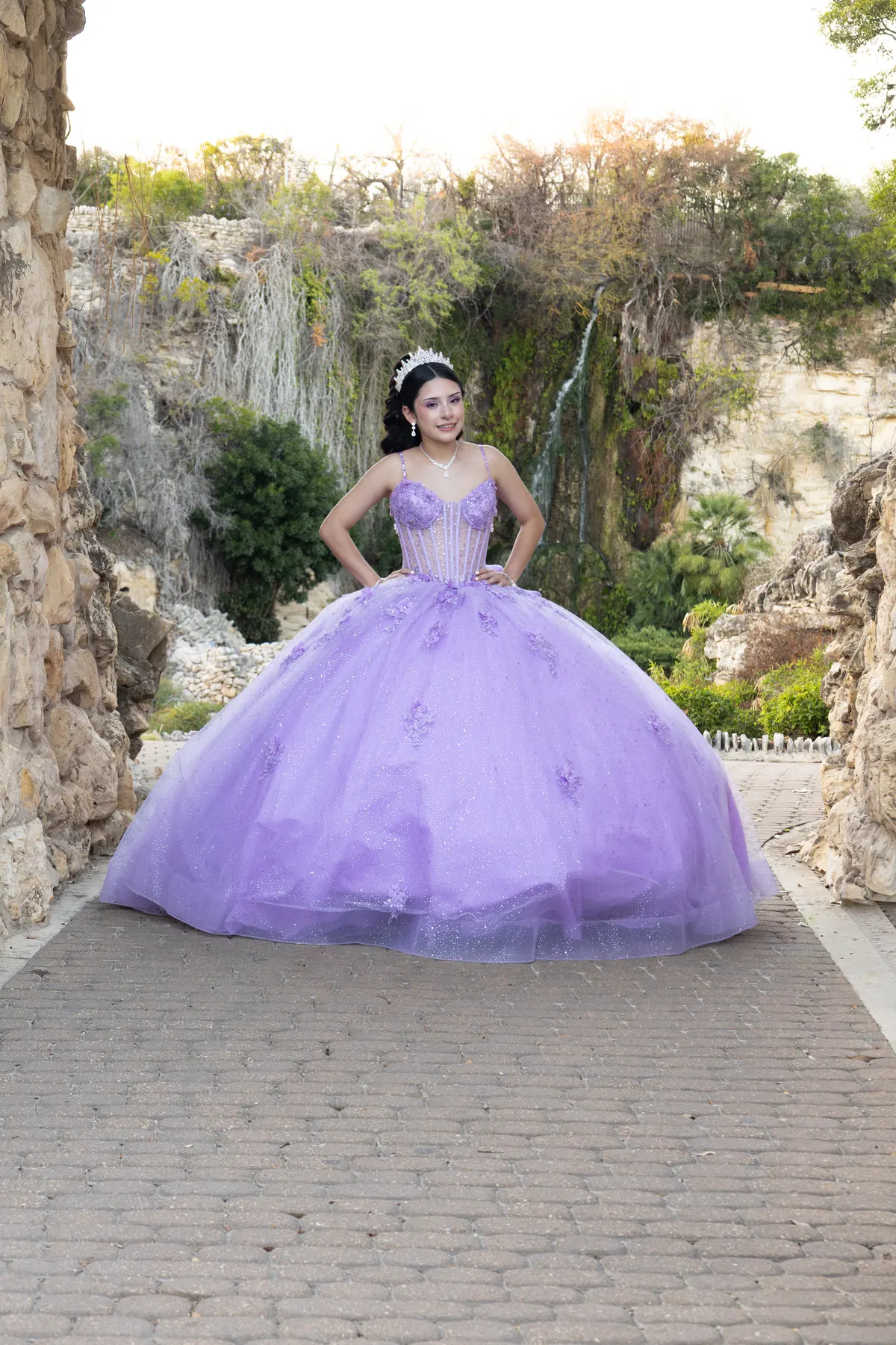 Quinceañera in a lavender gown photographed outdoors