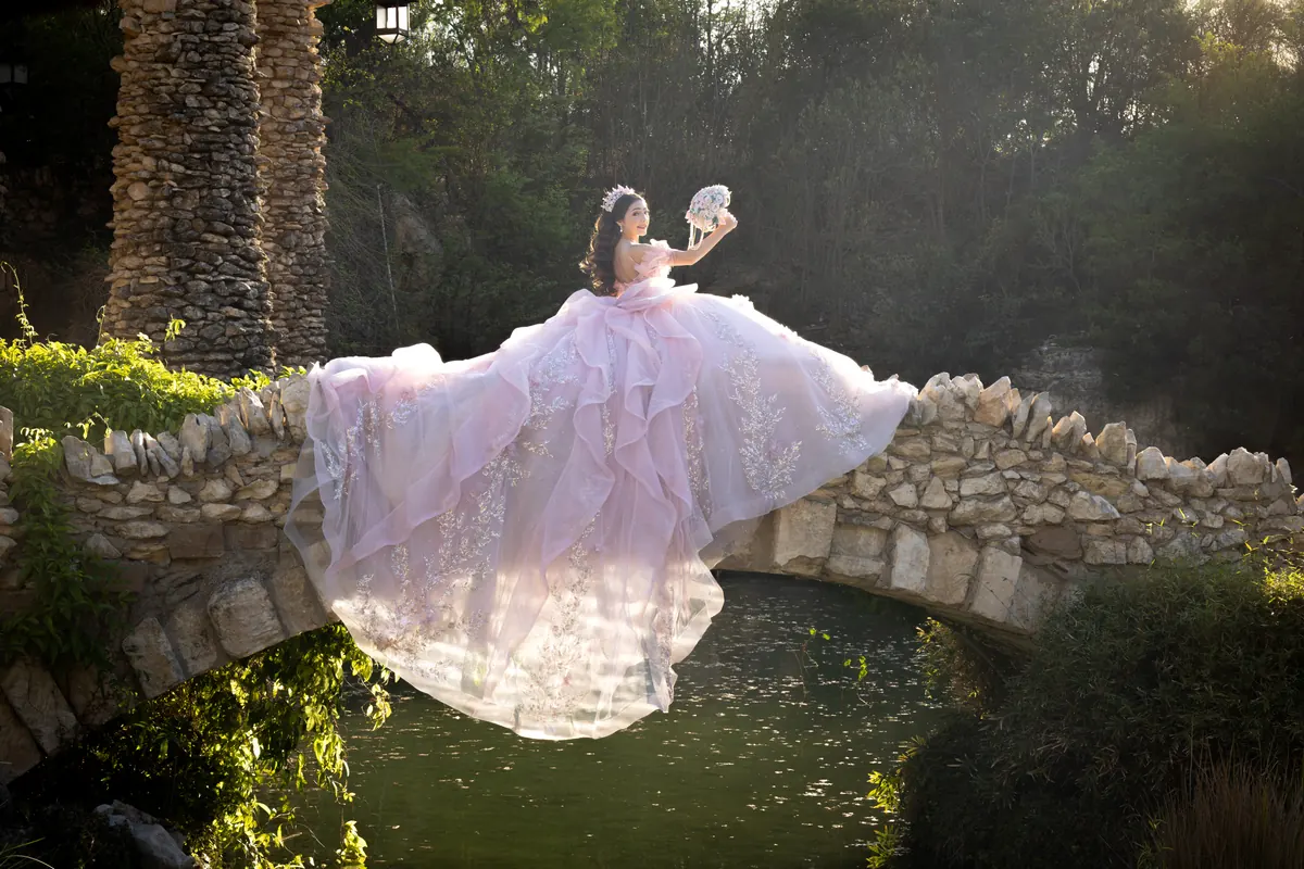 Quinceañera in a lavender gown captured in motion