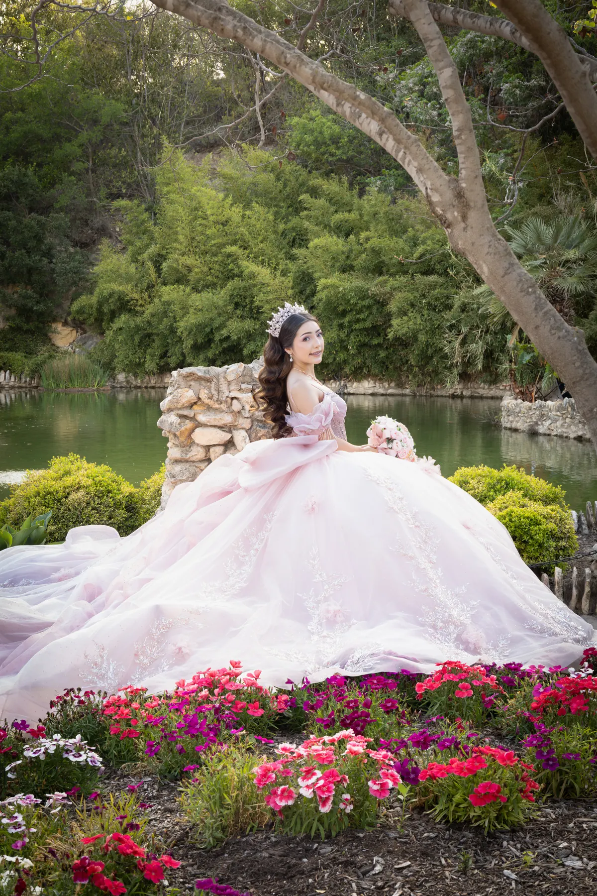 Quinceañera in a blush gown photographed in a garden